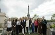 Group photograph taken in front of the Eiffel Tower in Paris.