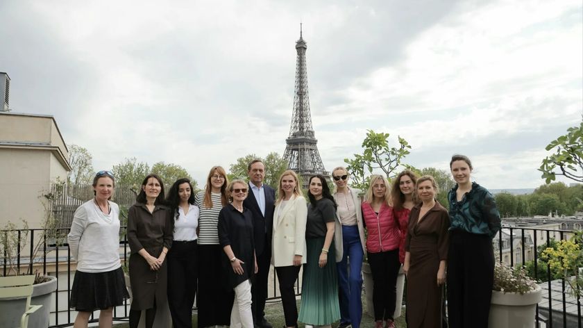 Group photograph taken in front of the Eiffel Tower in Paris.