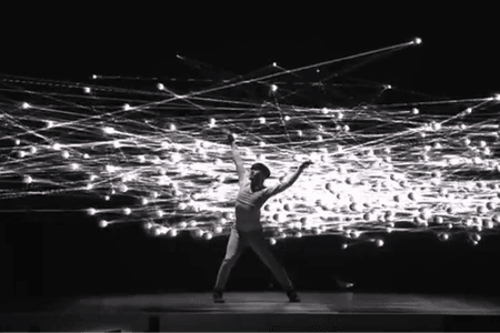 A person performing with a lot of lights.