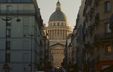 Photograph of the dome of the historic Sorbonne University building, viewed from a narrow alleyway.