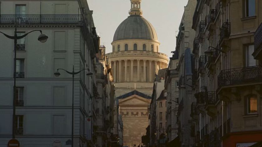 Photograph of the dome of the historic Sorbonne University building, viewed from a narrow alleyway.