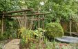 Photograph of a garden featuring wooden structures. Photograph of a garden featuring wooden structures.