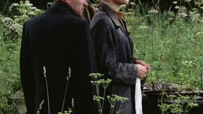 Film still from Andrei Tarkovsky’s Stalker, showing the three main characters in an overgrown, wild garden.